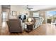 Spacious living room featuring vaulted ceilings, wood floors, a ceiling fan, and a comfortable seating area at 3102 Cordgrass Ct, The Villages, FL 32163