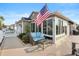 Inviting outdoor patio with comfortable seating and an American flag, perfect for relaxing or entertaining guests at 3102 Cordgrass Ct, The Villages, FL 32163
