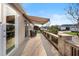 Inviting patio featuring a retractable awning, stone retaining wall, and a tranquil outdoor seating area at 3102 Cordgrass Ct, The Villages, FL 32163