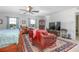 Cozy bedroom with arm chairs, a patterned rug, and multiple windows providing natural light at 3894 Arborvitae Way, Deland, FL 32724