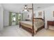 Spacious bedroom with a four-poster bed, ceiling fan, soft carpet and natural light at 3894 Arborvitae Way, Deland, FL 32724