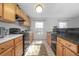 Bright kitchen featuring tile floors, wood cabinets, and granite countertops at 3894 Arborvitae Way, Deland, FL 32724