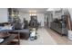 Spacious living room with tile flooring flowing into the dining area at 3894 Arborvitae Way, Deland, FL 32724