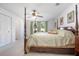 Large main bedroom with carpet flooring, a four-poster bed, and decorative window treatments at 3894 Arborvitae Way, Deland, FL 32724