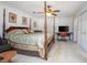 An airy main bedroom with four-poster bed, ceiling fan, and large closet at 3894 Arborvitae Way, Deland, FL 32724