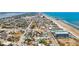 An aerial view showcases a coastal community near a beach with beachfront access at 409 S Grandview Ave, Daytona Beach, FL 32118