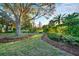 Lush landscaping enhances the natural beauty of this meticulously maintained backyard at 411 Foxhill Dr, Debary, FL 32713