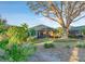 The screened lanai and mature landscaping create the perfect space for outdoor living at 411 Foxhill Dr, Debary, FL 32713