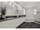 Modern bathroom with dual sinks, a soaking tub, and sleek, dark flooring at 411 Foxhill Dr, Debary, FL 32713