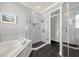 Modern bathroom with dual sinks, a soaking tub, and a glass-enclosed shower at 411 Foxhill Dr, Debary, FL 32713