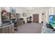 Bedroom with a ceiling fan, large window, a workspace, and a seating area, great for relaxing or productivity at 411 Foxhill Dr, Debary, FL 32713