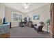 Bedroom with a ceiling fan, large window, and a comfortable seating area, great for a home office at 411 Foxhill Dr, Debary, FL 32713