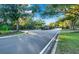 Scenic view of the community entrance with lush trees and well-maintained landscaping at 411 Foxhill Dr, Debary, FL 32713