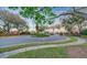 Community entrance featuring a roundabout with manicured landscaping and brick accents at 411 Foxhill Dr, Debary, FL 32713