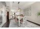Bright dining room features modern lighting, stylish decor, and a seamless transition to the kitchen area at 411 Foxhill Dr, Debary, FL 32713