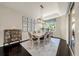 Bright dining room features modern lighting, stylish decor, and a view to the landscaped exterior at 411 Foxhill Dr, Debary, FL 32713
