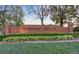 Fairway Hills brick entrance sign with manicured bushes and green lawn at 411 Foxhill Dr, Debary, FL 32713