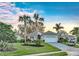 Beautiful single-story home featuring mature landscaping, palm trees, and a well-maintained lawn at 411 Foxhill Dr, Debary, FL 32713