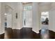 Bright foyer featuring dark hardwood floors, white walls, and elegant architecture at 411 Foxhill Dr, Debary, FL 32713