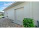 Attached single car garage with concrete driveway and surrounded by decorative rock and landscaping at 411 Foxhill Dr, Debary, FL 32713