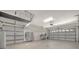 Spacious three car garage with epoxy flooring, bright lighting, and organized tool storage at 411 Foxhill Dr, Debary, FL 32713