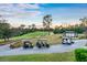View of a golf course with golf carts and a US flag in the background at 411 Foxhill Dr, Debary, FL 32713