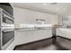 Modern kitchen with stainless steel appliances, stylish white cabinets, and dark wood flooring at 411 Foxhill Dr, Debary, FL 32713