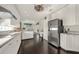 Gourmet kitchen with stainless steel refrigerator, granite countertops, and dark hardwood floors at 411 Foxhill Dr, Debary, FL 32713
