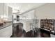 White kitchen with granite countertops, stainless steel appliances, dark wood floors, and bar seating at 411 Foxhill Dr, Debary, FL 32713
