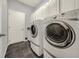 Well-equipped laundry room featuring modern washer and dryer units and ample storage space at 411 Foxhill Dr, Debary, FL 32713