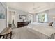 Bright main bedroom with tray ceiling, large windows and refined, dark wood furniture at 411 Foxhill Dr, Debary, FL 32713