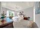 Spacious main bedroom featuring a tray ceiling, large window and tastefully coordinated furniture at 411 Foxhill Dr, Debary, FL 32713
