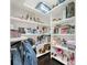 Walk-in pantry featuring a large assortment of items neatly arranged on shelves and a dark wood floor at 411 Foxhill Dr, Debary, FL 32713