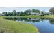 Scenic view of a pond with lush green landscaping and surrounding mature trees at 411 Foxhill Dr, Debary, FL 32713