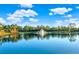 Beautiful pond featuring a fountain, surrounded by lush greenery and mature trees at 411 Foxhill Dr, Debary, FL 32713