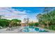 Community pool with lounge chairs and umbrellas, surrounded by lush landscaping at 411 Foxhill Dr, Debary, FL 32713
