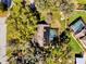 An aerial shot reveals a private pool and solar panels, set amid mature trees and verdant landscaping at 4612 Reynosa Sw Dr, Winter Haven, FL 33880