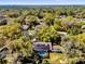 From above, a glimpse of a private pool and solar panels nestled among mature trees and a vibrant landscape at 4612 Reynosa Sw Dr, Winter Haven, FL 33880