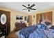 Bedroom with a ceiling fan, a wooden dresser, and an exterior door with glass panes at 4612 Reynosa Sw Dr, Winter Haven, FL 33880