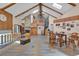 Bright living room featuring high ceilings, a stone fireplace, spiral staircase, and an open floor plan at 4612 Reynosa Sw Dr, Winter Haven, FL 33880