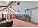 Cozy loft featuring a large TV, wood beams, and ample space for seating and entertainment at 4612 Reynosa Sw Dr, Winter Haven, FL 33880