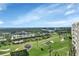 Beautiful aerial view of the community with lush landscaping, golf course, and blue skies above at 4670 Links Village Dr # B706, Ponce Inlet, FL 32127