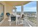 Relaxing balcony seating with a table and chairs overlooking stunning views of the surrounding landscape at 4670 Links Village Dr # B706, Ponce Inlet, FL 32127