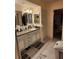Bathroom featuring an expansive vanity and an entrance to the adjoining bedroom at 4670 Links Village Dr # B706, Ponce Inlet, FL 32127