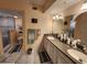 Bathroom features a dual sink vanity, large mirror, and a walk-in shower with decorative tile accent at 4670 Links Village Dr # B706, Ponce Inlet, FL 32127