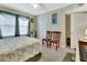 Inviting bedroom with a full-sized bed, seating, ceiling fan, and soft natural light at 4670 Links Village Dr # B706, Ponce Inlet, FL 32127