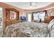 Bedroom featuring a large dresser, TV and a bay window with a leather chair, filled with natural light at 4670 Links Village Dr # B706, Ponce Inlet, FL 32127
