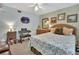 Comfortable bedroom with a full-sized bed, dresser, ceiling fan, and soft natural light at 4670 Links Village Dr # B706, Ponce Inlet, FL 32127