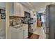 Well-equipped kitchen featuring stainless steel appliances and adjacent workstation at 4670 Links Village Dr # B706, Ponce Inlet, FL 32127