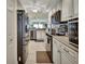 Modern kitchen with stainless steel appliances and white cabinetry at 4670 Links Village Dr # B706, Ponce Inlet, FL 32127